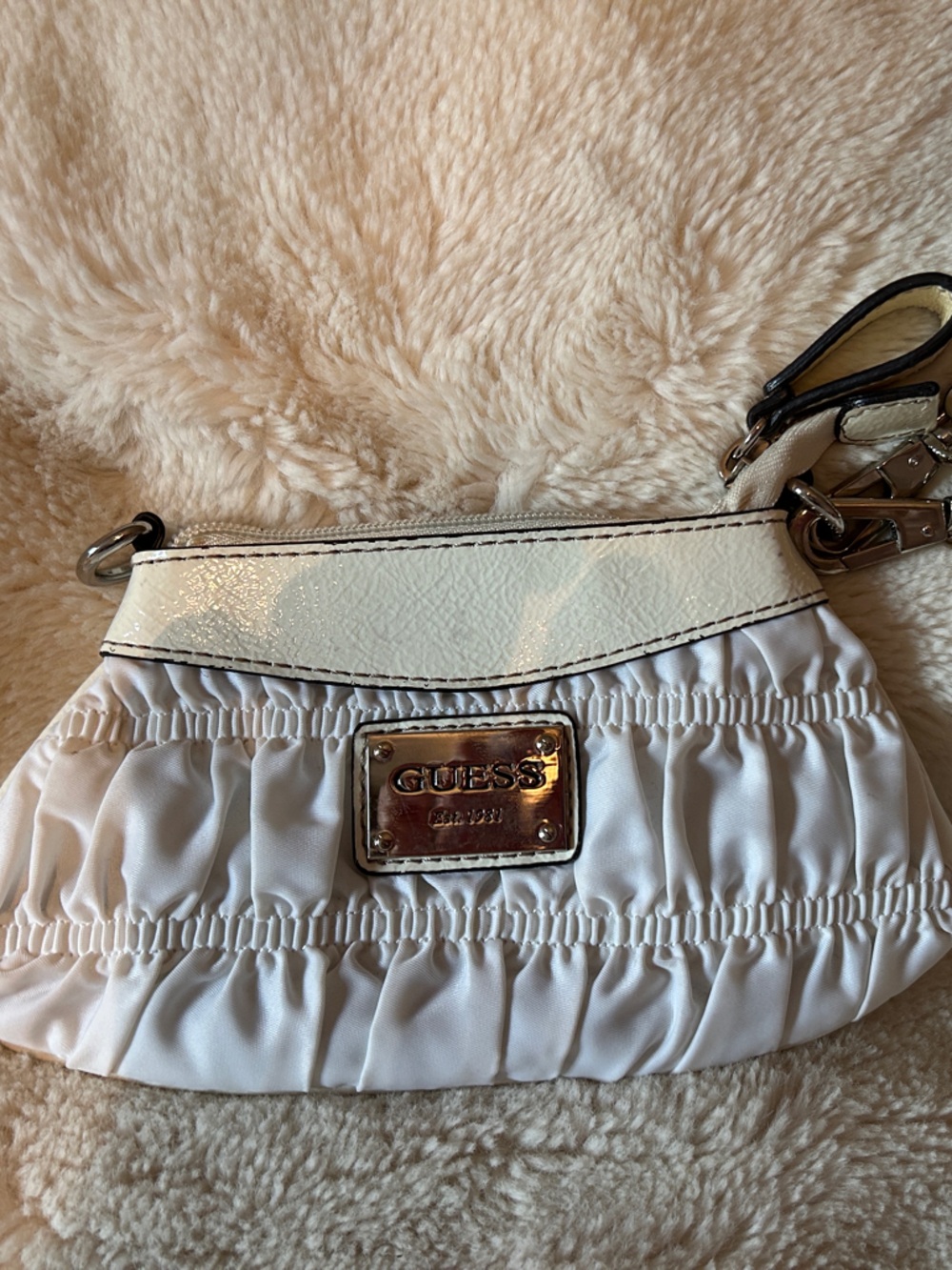 GUESS White Ruffle Wristlet with Gold Tone Logo Plate